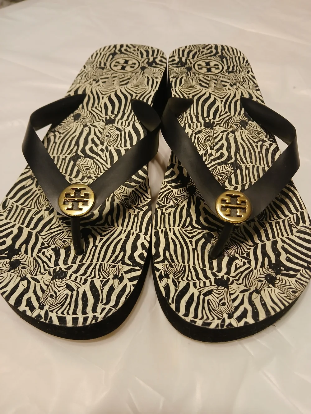 Tory Burch Ladies Black Zebra Flip Flops with Gold Logo